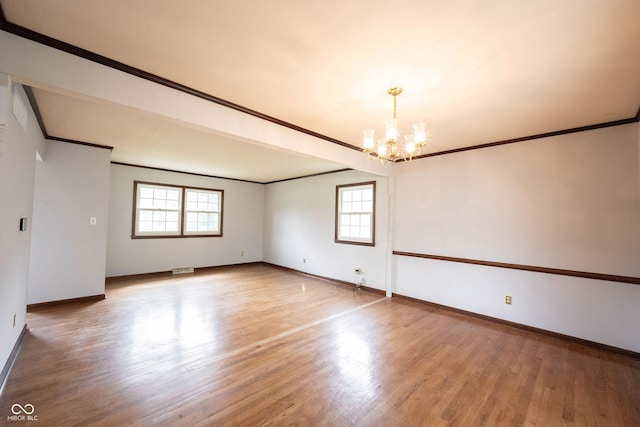 10244 Washington Blvd, Carmel, IN 46280 - unfurnished room featuring ornamental molding, a chandelier, healthy amount of natural light, wood finished floors, and baseboards