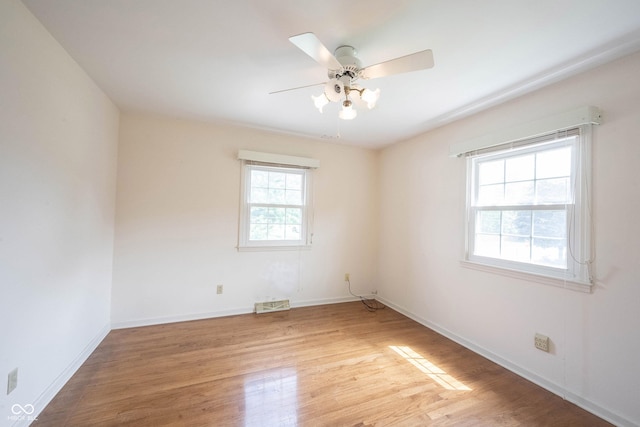 10244 Washington Blvd, Carmel, IN 46280 - empty room with light wood-style flooring, a ceiling fan, and baseboards