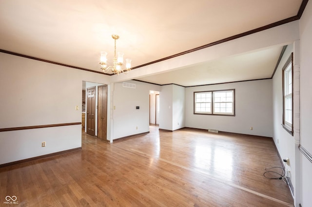 10244 Washington Blvd, Carmel, IN 46280 - spare room featuring a chandelier, ornamental molding, baseboards, and light wood-style floors