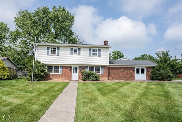 10244 Washington Blvd, Carmel, IN 46280 - colonial inspired home featuring a front lawn, a chimney, and brick siding