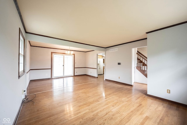 10244 Washington Blvd, Carmel, IN 46280 - unfurnished room featuring crown molding, a chandelier, baseboards, stairway, and light wood finished floors