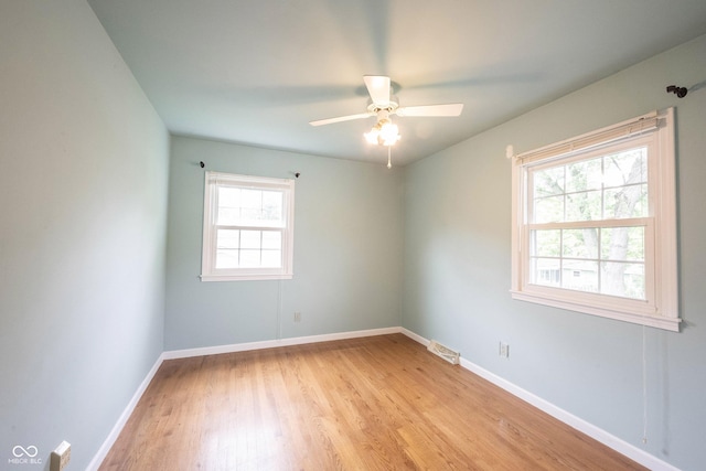 10244 Washington Blvd, Carmel, IN 46280 - spare room featuring light wood-style floors, baseboards, and ceiling fan