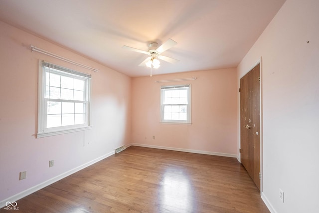 10244 Washington Blvd, Carmel, IN 46280 - spare room with light wood-style floors, ceiling fan, and baseboards
