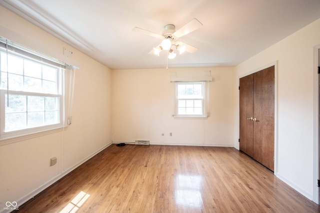 10244 Washington Blvd, Carmel, IN 46280 - unfurnished bedroom featuring light wood finished floors, baseboards, a closet, and ceiling fan