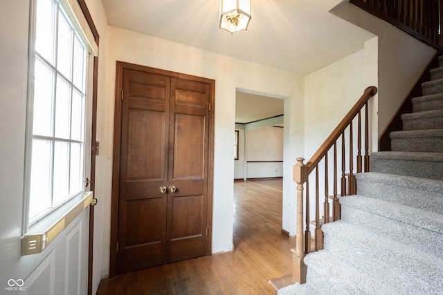 10244 Washington Blvd, Carmel, IN 46280 - foyer with wood finished floors, stairway, and baseboards