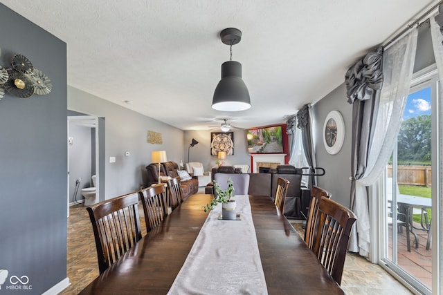2509 Cedarmill Dr, Franklin, IN 46131 - dining space with a ceiling fan, a tile fireplace, and stone finish flooring