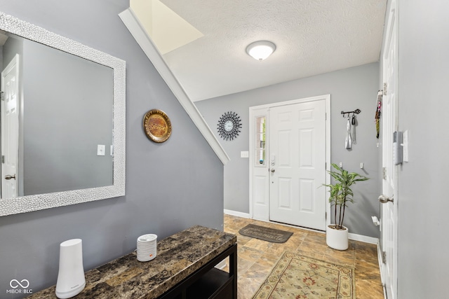2509 Cedarmill Dr, Franklin, IN 46131 - foyer entrance with a textured ceiling and baseboards