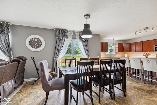2509 Cedarmill Dr, Franklin, IN 46131 - dining space with stone finish floors, baseboards, and a textured ceiling