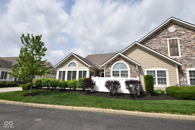 1150 Extraordinary Trl, Greenfield, IN 46140 - view of front of home featuring stone siding and a front lawn