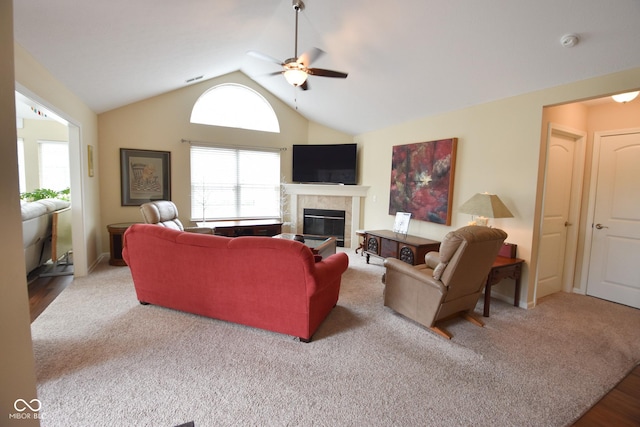 1150 Extraordinary Trl, Greenfield, IN 46140 - living room featuring a ceiling fan, a tile fireplace, vaulted ceiling, and carpet flooring