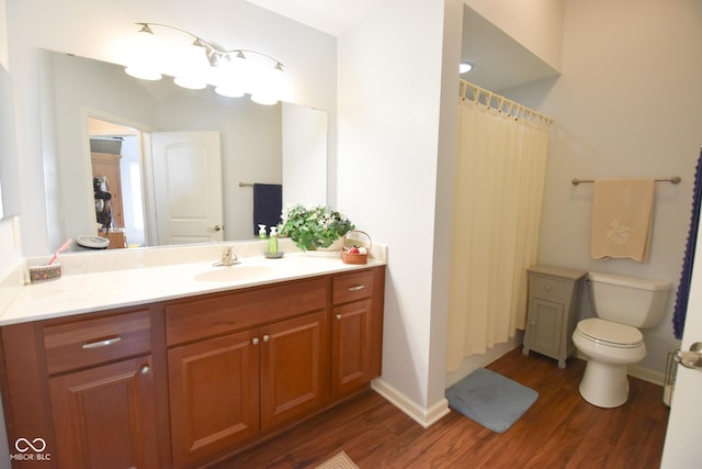 1150 Extraordinary Trl, Greenfield, IN 46140 - bathroom featuring wood finished floors, vanity, toilet, and baseboards
