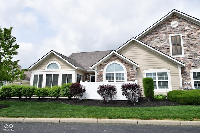 1150 Extraordinary Trl, Greenfield, IN 46140 - view of front facade featuring stone siding and a front yard