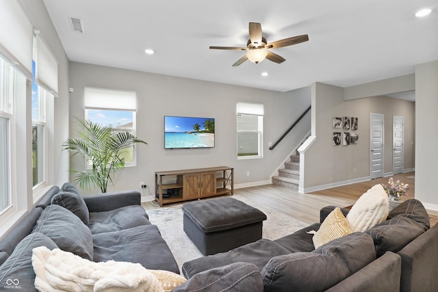 6917 Wolf Creek Ct, Whitestown, IN 46075 - living room with stairs, plenty of natural light, recessed lighting, a ceiling fan, and light wood finished floors