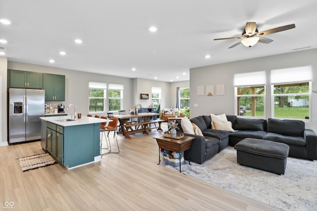 6917 Wolf Creek Ct, Whitestown, IN 46075 - living area featuring light wood finished floors, recessed lighting, and a ceiling fan