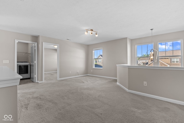 4539 Maldenhair Dr, Indianapolis, IN 46239 - empty room featuring washer / clothes dryer, light colored carpet, baseboards, and a textured ceiling