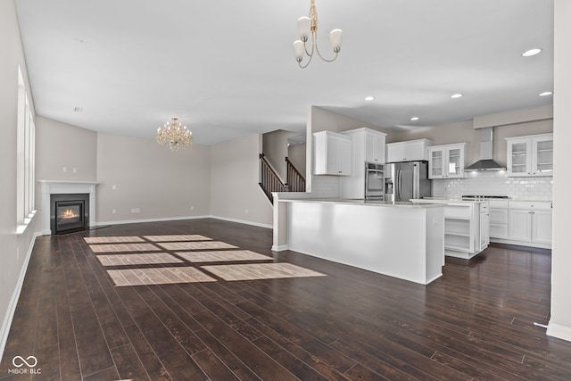 4539 Maldenhair Dr, Indianapolis, IN 46239 - unfurnished living room featuring a chandelier, baseboards, a glass covered fireplace, dark wood-type flooring, and recessed lighting