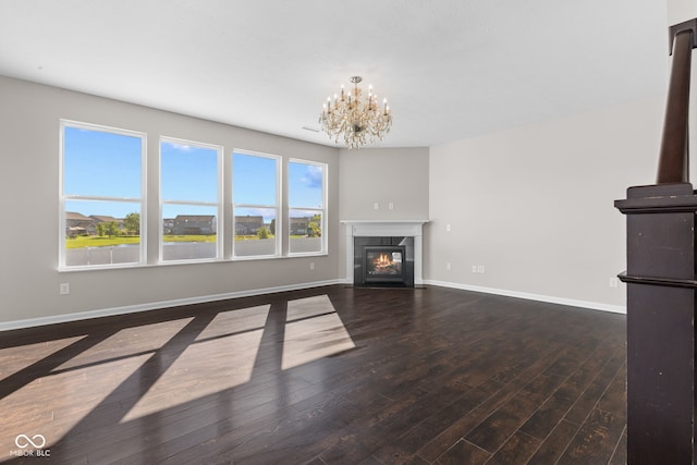 4539 Maldenhair Dr, Indianapolis, IN 46239 - unfurnished living room featuring hardwood / wood-style floors, a chandelier, baseboards, and a high end fireplace