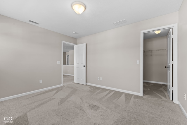 4539 Maldenhair Dr, Indianapolis, IN 46239 - unfurnished bedroom featuring carpet flooring, baseboards, and a walk in closet