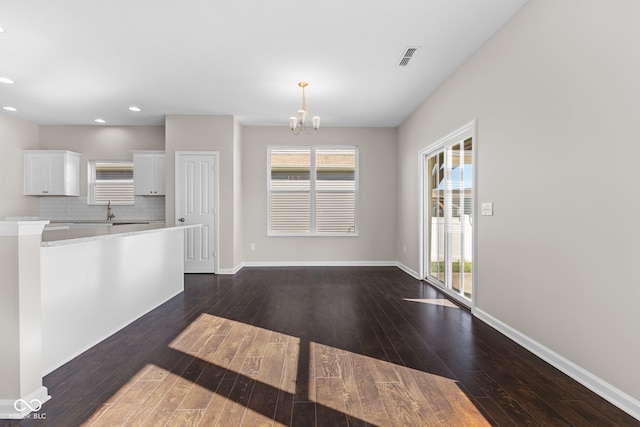 4539 Maldenhair Dr, Indianapolis, IN 46239 - kitchen featuring a chandelier, light countertops, dark wood-style flooring, white cabinetry, and recessed lighting