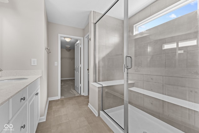4539 Maldenhair Dr, Indianapolis, IN 46239 - full bathroom with vanity, a shower stall, baseboards, and a walk in closet