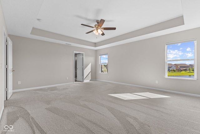 4539 Maldenhair Dr, Indianapolis, IN 46239 - empty room featuring a raised ceiling, a ceiling fan, baseboards, and light carpet