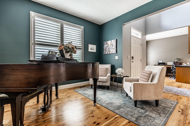 9804 Wentworth Ct, Carmel, IN 46032 - sitting room featuring wood-type flooring, a desk, and a textured ceiling