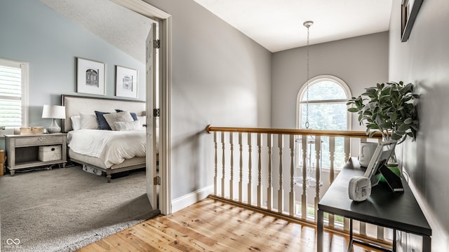 9804 Wentworth Ct, Carmel, IN 46032 - corridor with wood finished floors, baseboards, and lofted ceiling