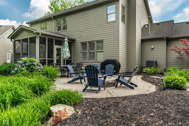 9804 Wentworth Ct, Carmel, IN 46032 - rear view of property featuring a sunroom, a patio area, a fire pit, and central air condition unit