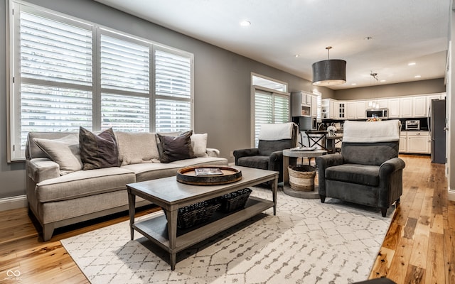 9804 Wentworth Ct, Carmel, IN 46032 - living area with light wood finished floors, recessed lighting, and baseboards