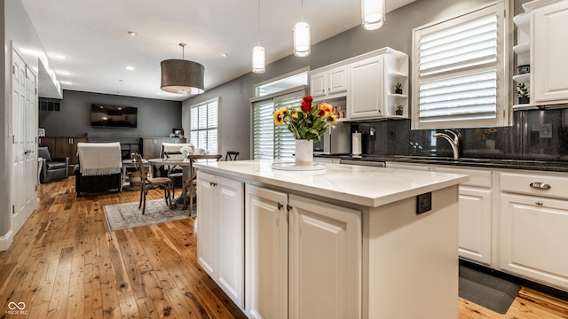 9804 Wentworth Ct, Carmel, IN 46032 - kitchen with open shelves, light wood-style floors, backsplash, white cabinetry, and recessed lighting