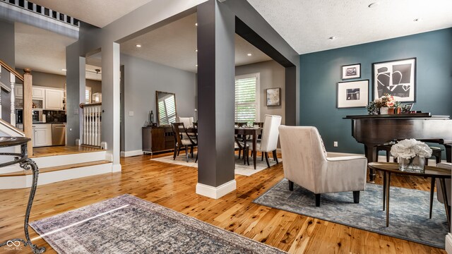 9804 Wentworth Ct, Carmel, IN 46032 - sitting room with light wood-style flooring, baseboards, and recessed lighting