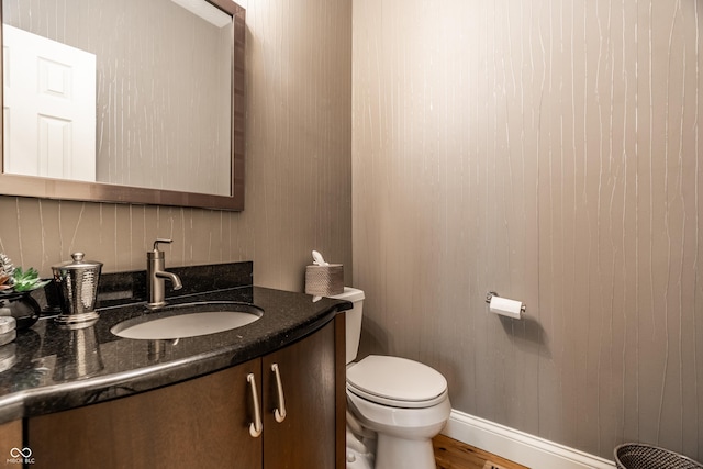 9804 Wentworth Ct, Carmel, IN 46032 - half bath with vanity, toilet, wood finished floors, and baseboards