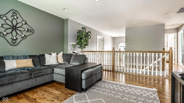 9804 Wentworth Ct, Carmel, IN 46032 - living room featuring wood finished floors and recessed lighting