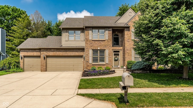 9804 Wentworth Ct, Carmel, IN 46032 - view of front of house featuring concrete driveway, brick siding, a front lawn, roof with shingles, and an attached garage