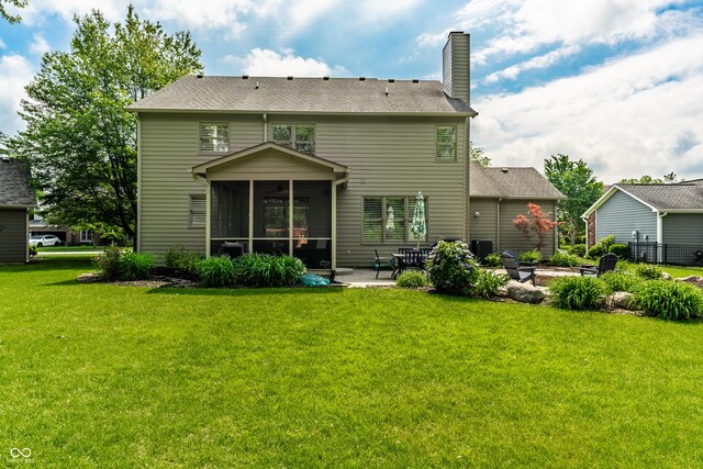 9804 Wentworth Ct, Carmel, IN 46032 - back of property featuring a patio area, a sunroom, a yard, and a chimney