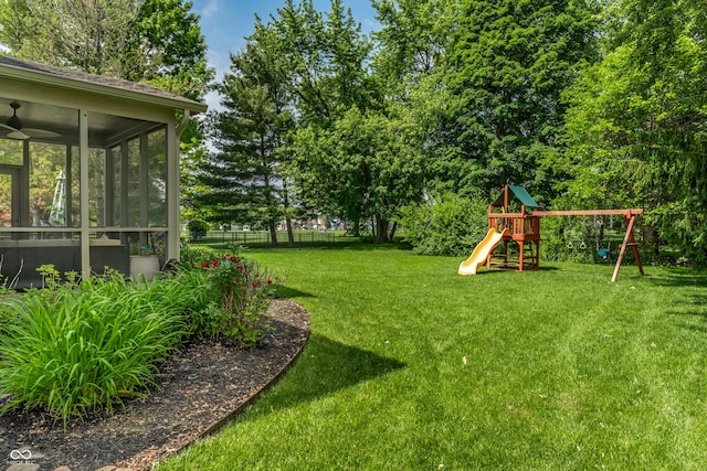 9804 Wentworth Ct, Carmel, IN 46032 - view of yard with a playground, a sunroom, and view of wooded area