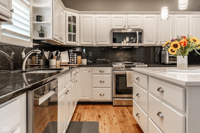 9804 Wentworth Ct, Carmel, IN 46032 - kitchen featuring stainless steel appliances, a sink, white cabinets, and decorative backsplash