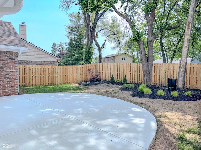 6845 Arjay Dr, Indianapolis, IN 46217 - fenced backyard with a patio area