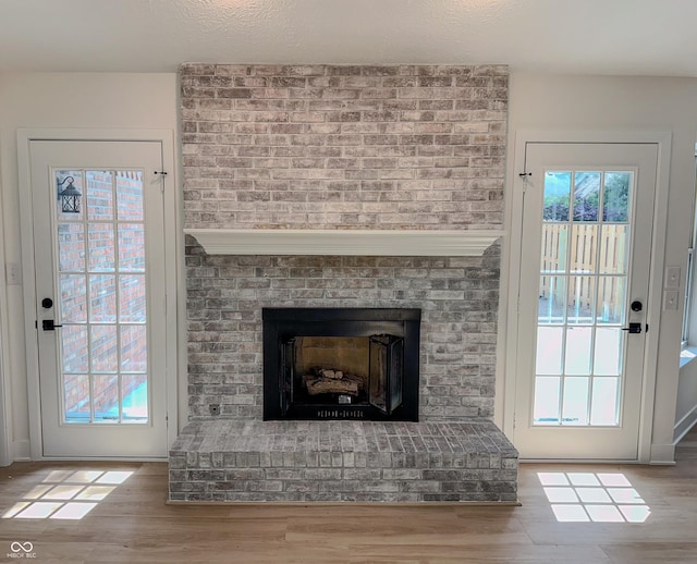 6845 Arjay Dr, Indianapolis, IN 46217 - detailed view of a brick fireplace and wood finished floors