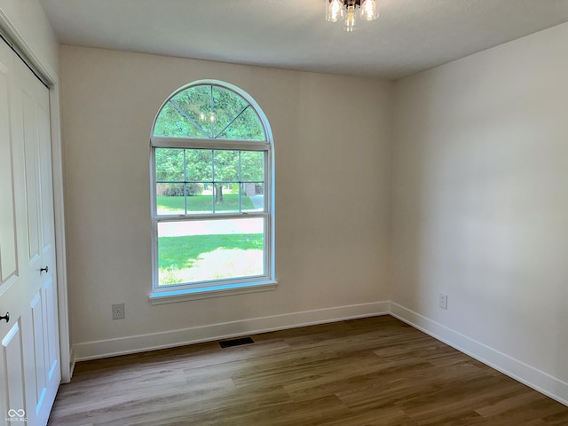 6845 Arjay Dr, Indianapolis, IN 46217 - spare room with wood finished floors, plenty of natural light, and baseboards