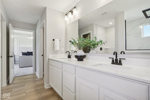 577 Dalton Way, Avon, IN 46123 - full bathroom with double vanity, baseboards, and wood tiled floors