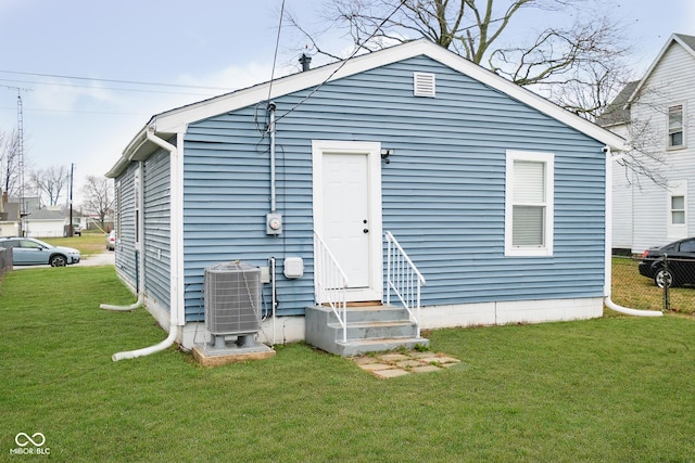 2209 W 9th St, Muncie, IN 47302 - rear view of property with entry steps, central AC unit, and a yard