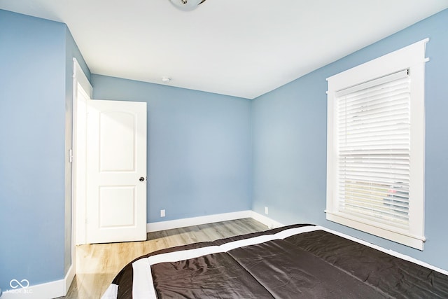 2209 W 9th St, Muncie, IN 47302 - unfurnished bedroom featuring wood finished floors and baseboards