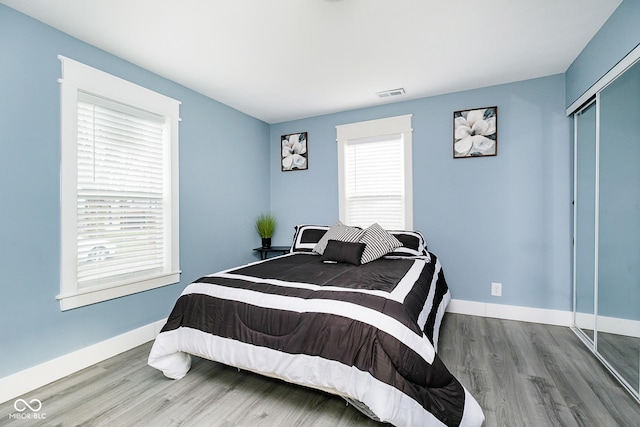 2209 W 9th St, Muncie, IN 47302 - bedroom featuring wood finished floors, a closet, and baseboards