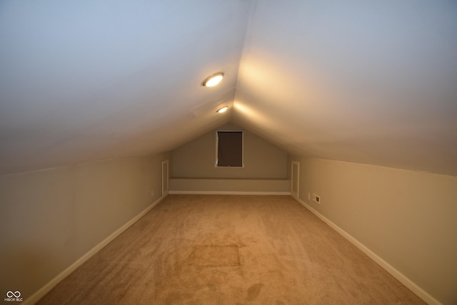 4231 Carrollton Ave, Indianapolis, IN 46205 - additional living space featuring vaulted ceiling, light carpet, and baseboards