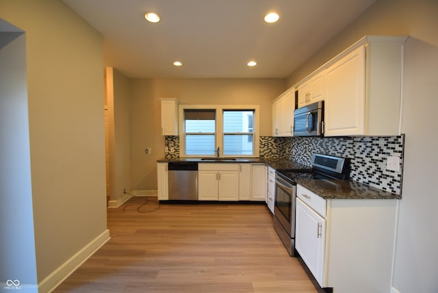 4231 Carrollton Ave, Indianapolis, IN 46205 - kitchen with stainless steel appliances, decorative backsplash, white cabinetry, and recessed lighting