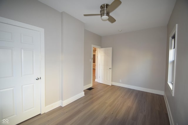 4231 Carrollton Ave, Indianapolis, IN 46205 - unfurnished bedroom with wood finished floors, baseboards, and a ceiling fan