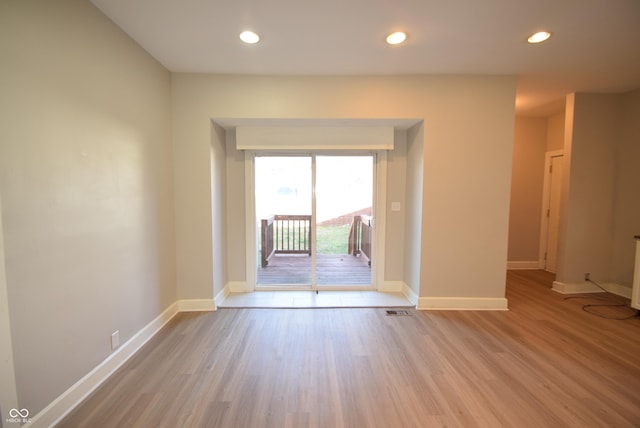 4231 Carrollton Ave, Indianapolis, IN 46205 - empty room with wood finished floors, recessed lighting, and baseboards