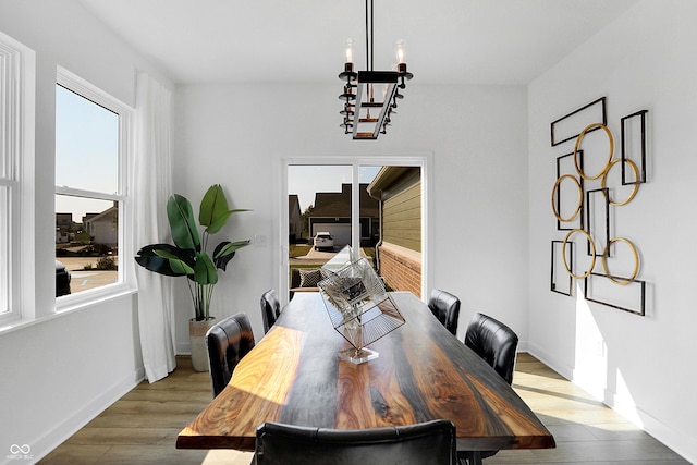 15387 Alperton Rd, Fishers, IN 46037 - dining room with a chandelier, wood finished floors, and baseboards