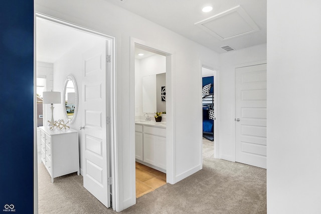 15387 Alperton Rd, Fishers, IN 46037 - corridor featuring light colored carpet, a sink, recessed lighting, and attic access